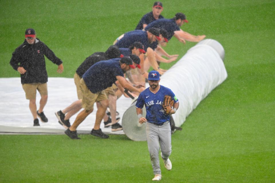 Jun 23, 2024; Cleveland, Ohio, USA; Toronto Blue Jays left fielder Davis Schneider (36) runs off the field during a rain delay against the Cleveland Guardians at Progressive Field. Mandatory Credit: David Richard-USA TODAY Sports