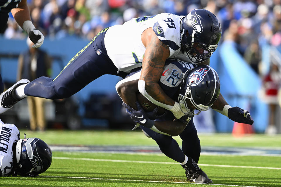 Seattle Seahawks defensive end Leonard Williams (99) tackles Tennessee Titans running back Tyjae Spears during the first half of an NFL football game on Sunday, Dec. 24, 2023, in Nashville, Tenn. (AP Photo/John Amis)