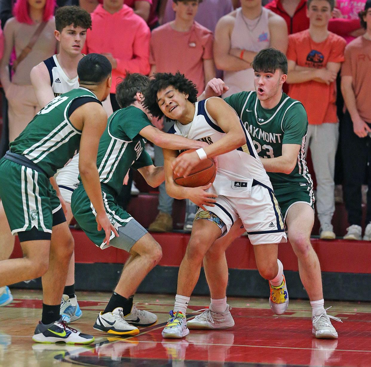 AB Willaims guard Tristan Rodriguez fights a few Spartans for a loose ball.Archbishop Williams defeats Oakmont to advance in MIAA state championship tournament action on Friday March 10, 2023 