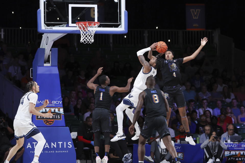 In a photo provided by Bahamas Visual Services, Villanova' s Hakim Hart, second from top right, shoots while guarded by Memphis' Ashton Hardaway (4) during an NCAA college basketball game in the Battle 4 Atlantis at Paradise Island, Bahamas, Friday, Nov. 24, 2023. (Tim Aylen/Bahamas Visual Services via AP)