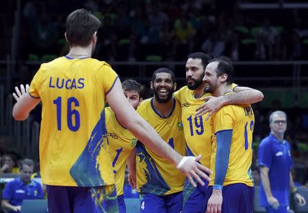 2016 Rio Olympics - Volleyball - Men's Gold Medal Match Italy v Brazil - Maracanazinho - Rio de Janeiro, Brazil - 21/08/2016. Lucas (BRA) of Brazil, Bruno (BRA) of Brazil, Wallace Leandro De Souza (BRA) of Brazil, Mauricio (BRA) of Brazil and Lipe (BRA) of Brazil celebrate a point. REUTERS/Yves Herman