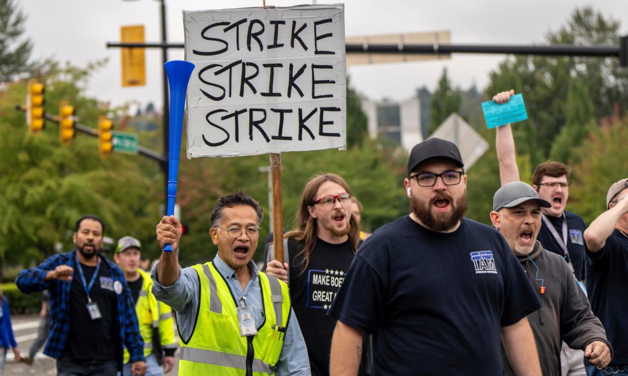 <span>Union members march to vote on a contract offer with airplane maker Boeing on Thursday in Renton, Washington.</span><span>Photograph: Stephen Brashear/AP</span>