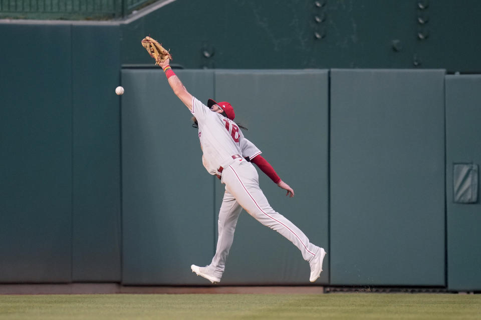 Philadelphia Phillies center fielder Brandon Marsh reaches but is unable to catch a fly ball double that was hit by Washington Nationals' CJ Abrams in the second inning of a baseball game, Friday, June 2, 2023, in Washington. (AP Photo/Patrick Semansky)