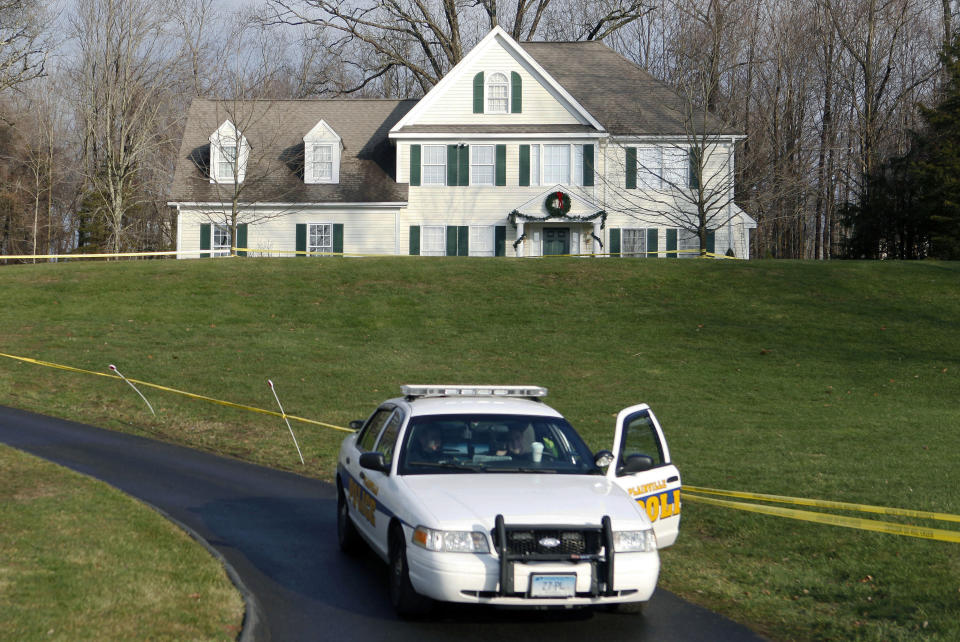 FILE - In this Dec. 18, 2012, file photo, a police cruiser sits in the driveway of the home of Nancy Lanza in Newtown, Conn., the Colonial-style house where she had lived with her son Adam Lanza. Documents from the investigation into the massacre at Sandy Hook Elementary School are shedding light on the Lanza’s anger, scorn for other people, and deep social isolation in the years leading up to the shooting. He fatally shot his mother there before driving to the school and ultimately killed himself. (AP Photo/Jason DeCrow, File)