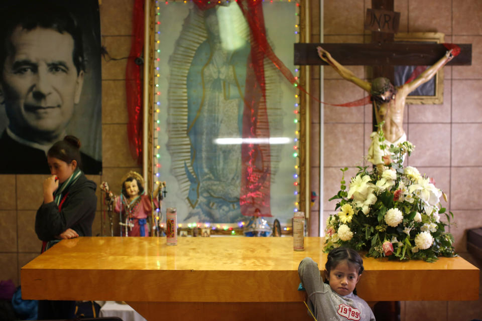 In this Feb. 26, 2019 photo, migrants rest in the chapel of the San Juan Bosco migrant shelter, in Nogales, Mexico. For years, Catholic-led, U-S.-based nonprofits have been at the forefront of efforts to support migrants and asylum seekers along the Mexican border. Tough new border policies, coupled with the COVID-19 pandemic, have drastically changed their work, much of which now takes place in Mexico. (AP Photo/Dario Lopez-Mills)