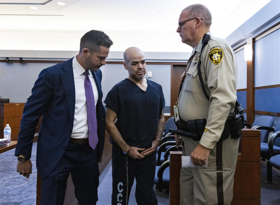 FILE - Outgoing Clark County Public Administrator Robert Telles, center, leaves the courtroom with David Lopez-Negrete, a public defender, left, after his arraignment at the Regional Justice Center, on Tuesday, Sept. 20, 2022, in Las Vegas. Telles, a former Democratic elected county official, is jailed awaiting completion of the police investigation and a hearing of evidence alleging that he killed Las Vegas Review-Journal investigative journalist Jeff German. (Bizuayehu Tesfaye/Las Vegas Review-Journal via AP, File)