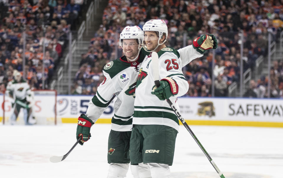 Minnesota Wild's Declan Chisholm (47) and Jonas Brodin (25) celebrate a goal against the Edmonton Oilers during the third period of an NHL hockey game Friday, Feb. 23, 2024, in Edmonton, Alberta. (Jason Franson/The Canadian Press via AP)