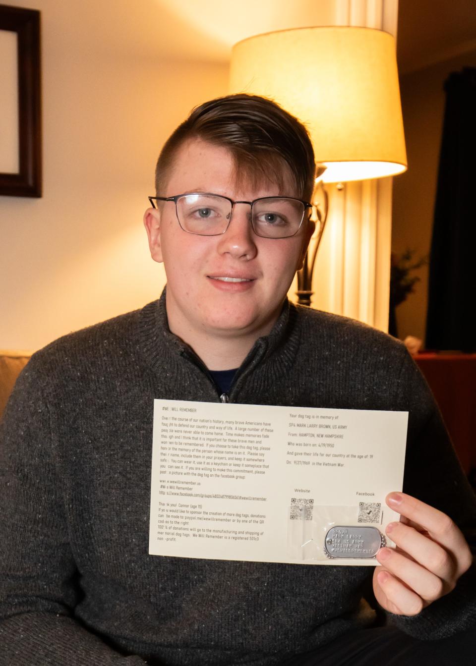 Connor Nicol, 15, of Hampton, holds a dog tag and a card that he created to remember SP4 Mark Larry Brown, U.S. Army, from Hampton NH. Brown was born on April 19, 1950, and was killed in the Vietnam War on September 27, 1969.