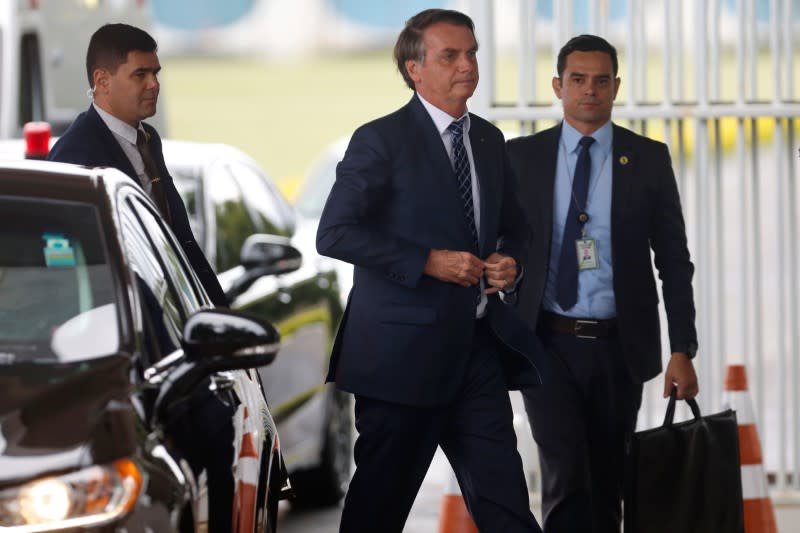 Brazil's President Jair Bolsonaro walks as he leaves the Alvorada Palace in Brasilia