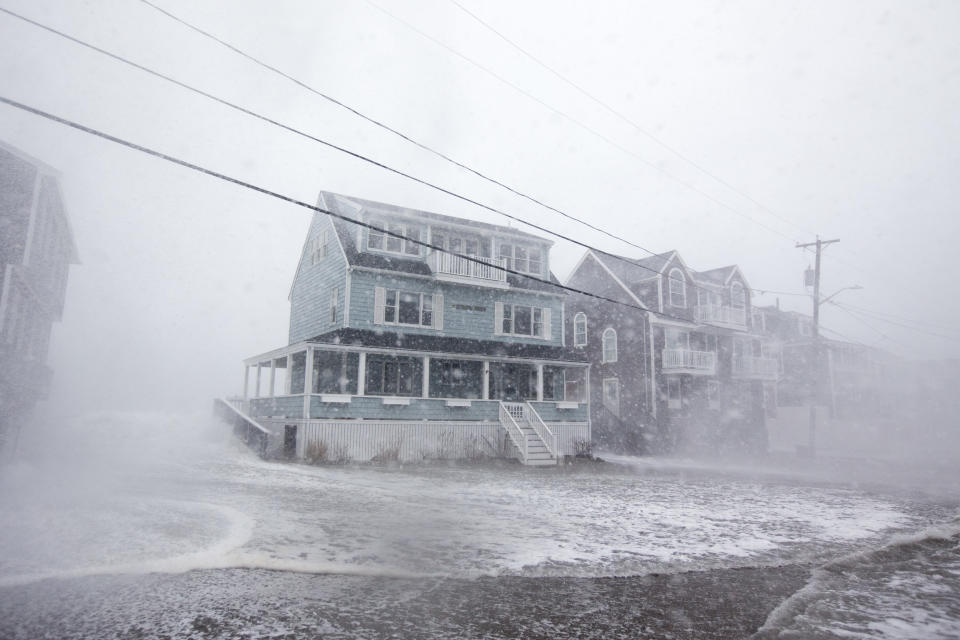 <p>Waves crash over a house on Lighthouse Rd. as the road starts to flood during a large coastal storm on March 2, 2018 in Scituate, Mass. (Photo: Scott Eisen/Getty Images) </p>