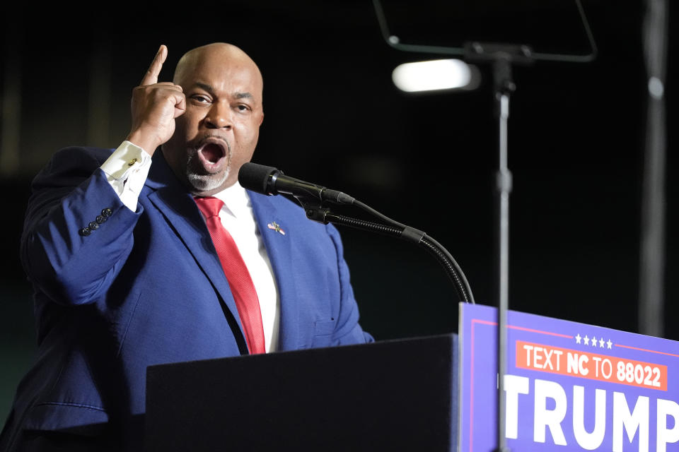 FILE - North Carolina Lt. Gov. Mark Robinson speaks before Republican presidential candidate former President Donald Trump at a campaign rally March 2, 2024, in Greensboro, N.C. In his bid to become North Carolina's first Black governor, Robinson assails government safety-net spending as a "plantation of welfare and victimhood" that he says has mired generations of Black people in "dependency" and poverty. But the firebrand lieutenant governor's political rise wouldn't have been possible without it. (AP Photo/Chris Carlson, File)