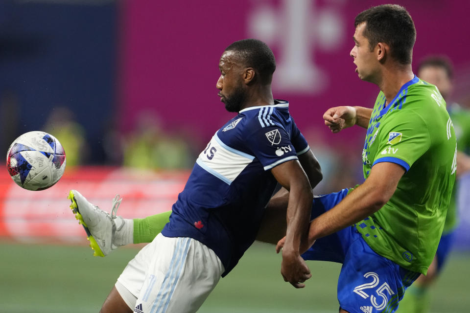 Seattle Sounders defender Jackson Ragen, right, tips the ball away from Vancouver Whitecaps midfielder Junior Hoilett during the first half of an MLS soccer match Saturday, Oct. 7, 2023, in Seattle. (AP Photo/Lindsey Wasson)