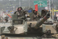 <p>South Korean army soldiers ride a K-1 tank during the annual exercise in Paju, South Korea near the border with North Korea, Wednesday, July 5, 2017. (Photo: Ahn Young-joon/AP) </p>