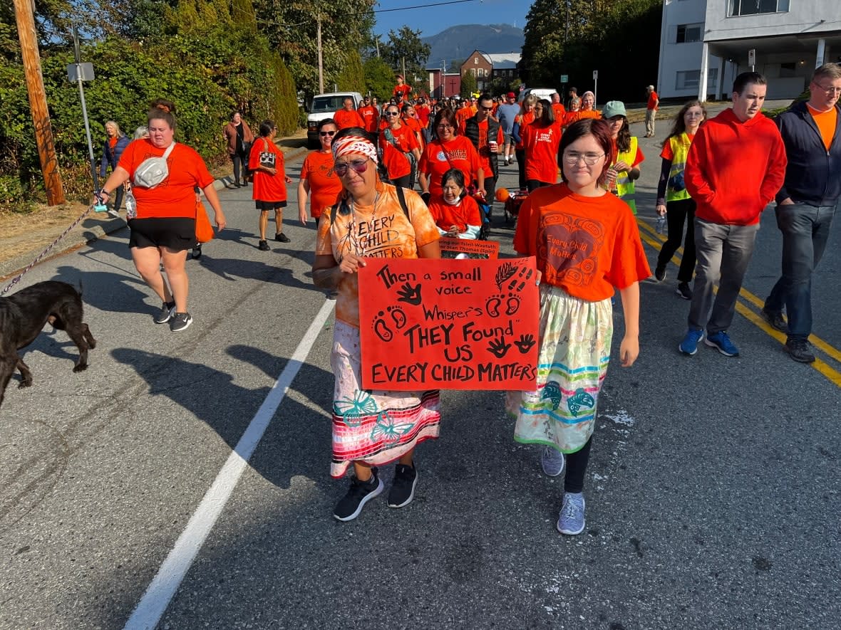 Marchers at a North Vancouver pilgrimage on the second National Day for Truth and Reconciliation in 2022 sang songs, held up banners, and beat drums to remember the children who attended residential schools and celebrate community. Sept. 30 will be a statutory holiday across B.C. beginning in 2023. (Benoit Ferradini/CBC - image credit)