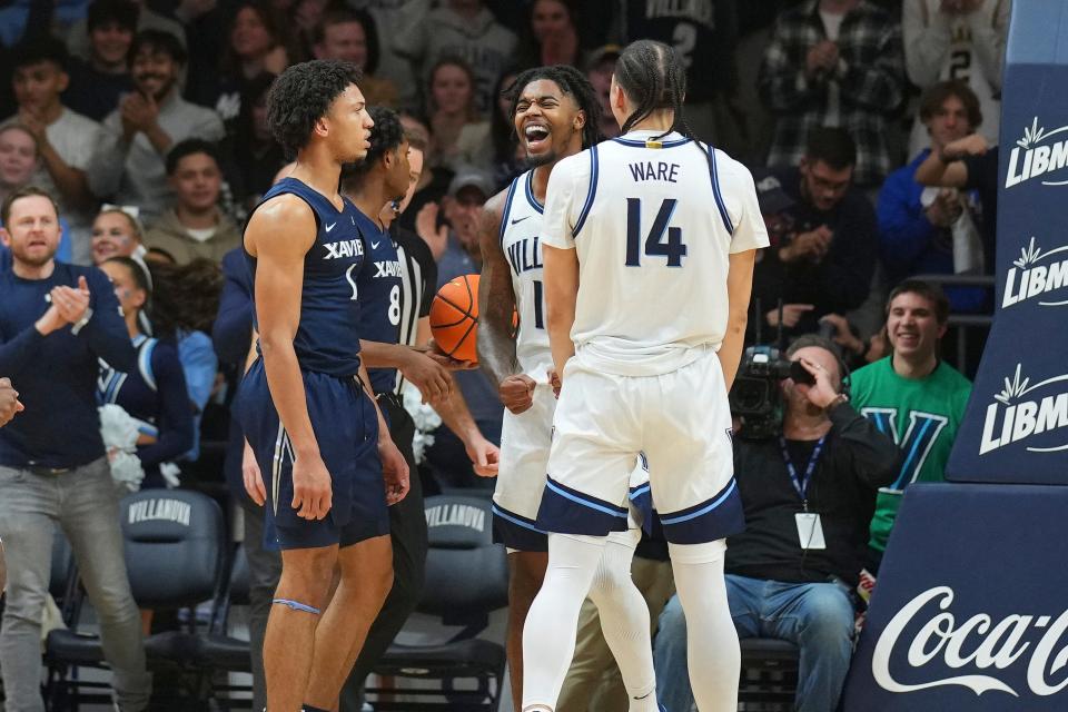 VILLANOVA, PENNSYLVANIA - JANUARY 3: Hakim Hart #13 and Lance Ware #14 of the Villanova Wildcats react in front of Desmond Claude #1 and Quincy Olivari #8 of the Xavier Musketeers in the first half at Finneran Pavilion on January 3, 2024 in Villanova, Pennsylvania.
