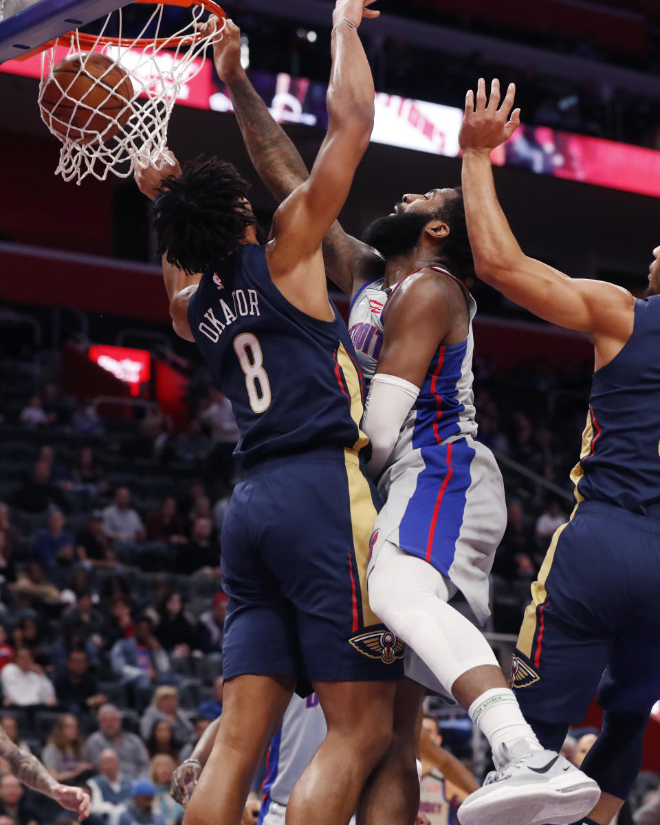 Detroit Pistons center Andre Drummond, center, dunks on New Orleans Pelicans center Jahlil Okafor (8) during the first half of an NBA basketball game, Monday, Jan. 13, 2020, in Detroit. (AP Photo/Carlos Osorio)