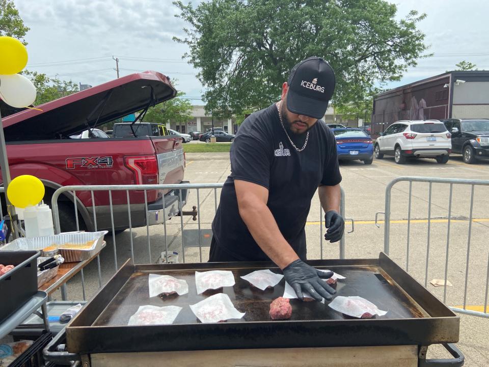 Iceburg chef  prepping burgers on the grill at the 2023 Detroit Burger Battle.