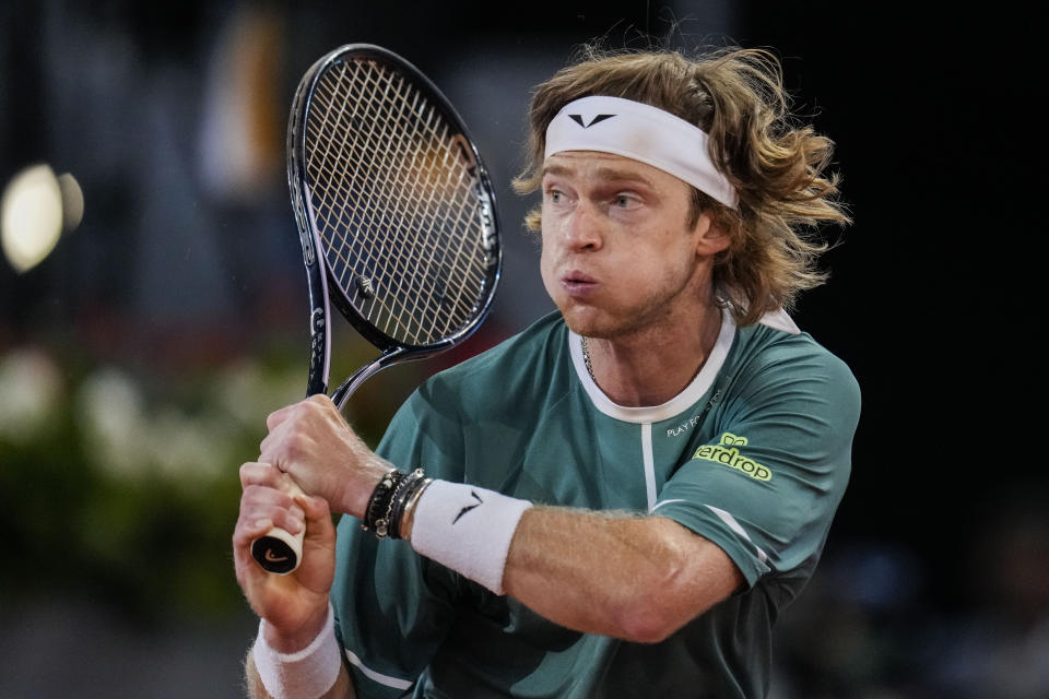 Andrey Rublev, of Russia, returns the ball to Carlos Alcaraz, of Spain, during the Mutua Madrid Open tennis tournament in Madrid, Wednesday, May 1, 2024. (AP Photo/Manu Fernandez)