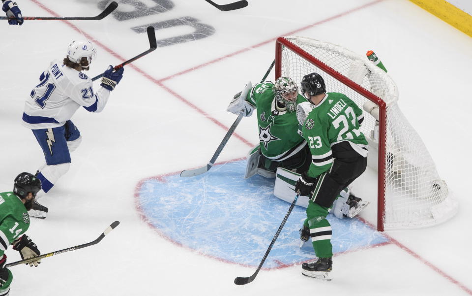 Tampa Bay Lightning center Brayden Point (21) scores on Dallas Stars goaltender Anton Khudobin (35) as Stars defenseman Esa Lindell (23) looks on during the second period of Game 4 of the NHL hockey Stanley Cup Final, Friday, Sept. 25, 2020, in Edmonton, Alberta. (Jason Franson/The Canadian Press via AP)