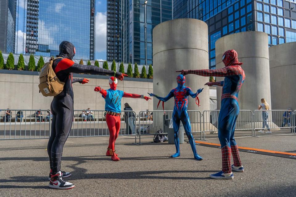 Four cosplayers dressed as different versions of Spider-Man at New York Comic Con 2021.