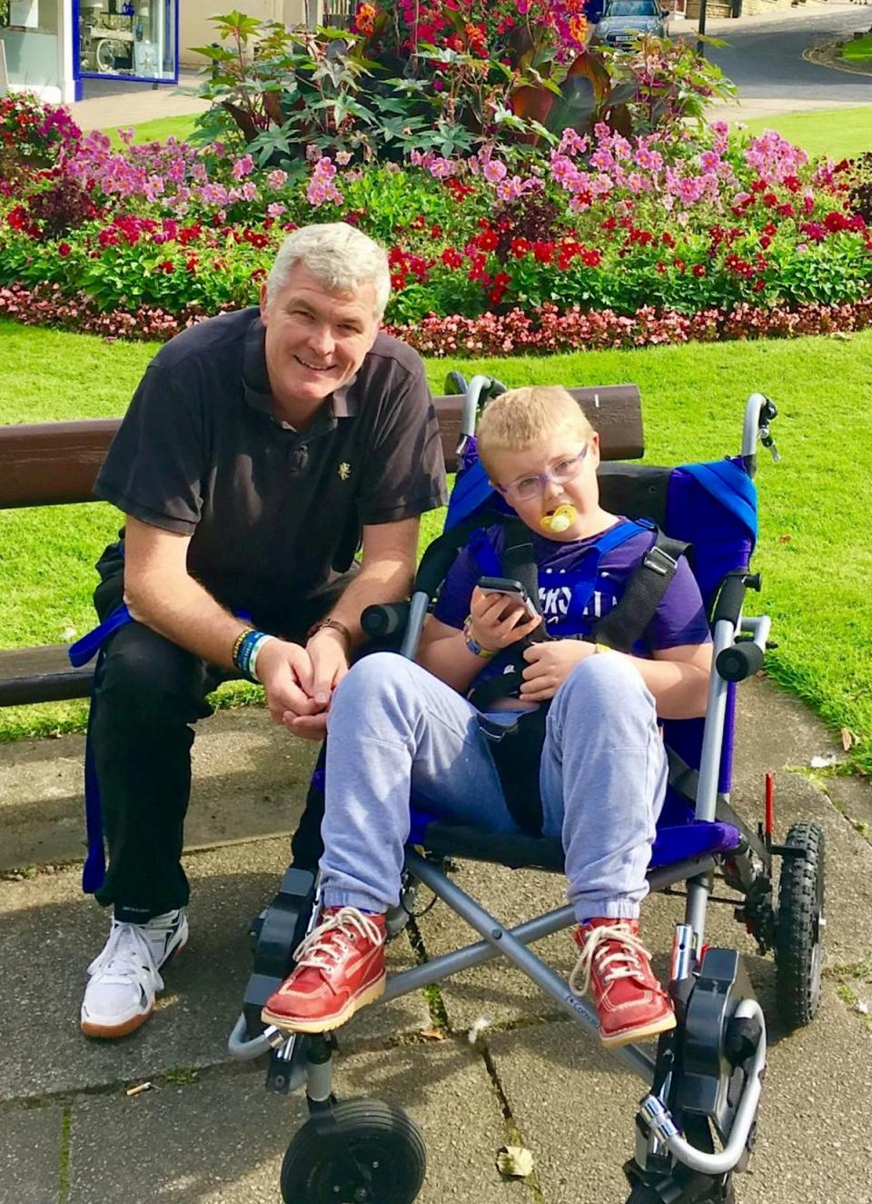 Adam with father Chris, who died from cancer in 2020 (Irwin Mitchell / SWNS)