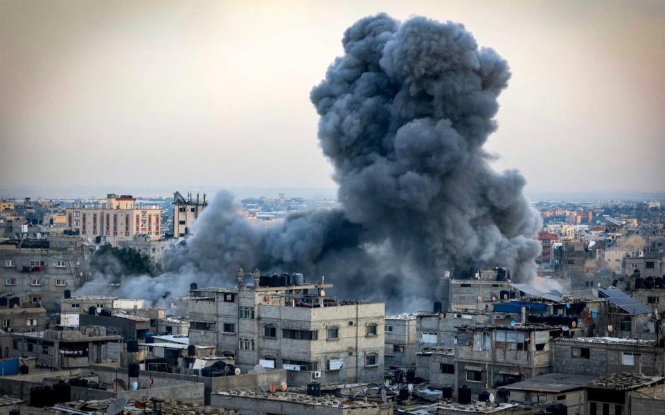 A smoke plume erupts during Israeli bombardment in Rafah in the southern Gaza Strip