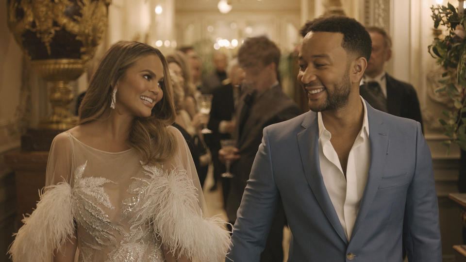 This undated image provided by Genesis shows Chrissy Teigen and her husband John Legend in a scene from the company's 2020 Super Bowl NFL football spot. (Genesis via AP)