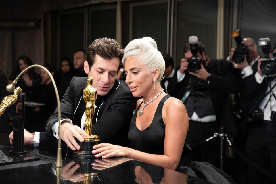 Mark Ronson and Lady Gaga having their Oscars engraved with their names during the Governors Ball after the Academy Awards in 2019.