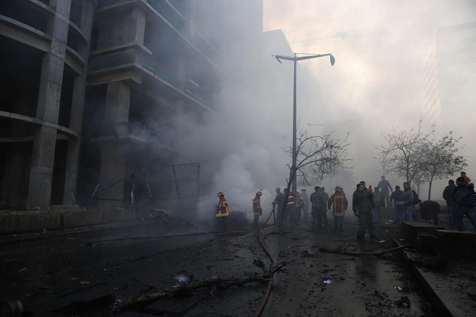 Fire fighting and army personnel inspect the site of an explosion in Beirut's downtown area