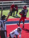 Liberty wide receiver Demario Douglas (3) scores a touchdown as he is defended by Massachusetts player Cody Jones (29) during the first half of an NCAA college football game on Friday, Nov. 27, 2020, at Williams Stadium in Lynchburg, Va. (AP Photo/Shaban Athuman)