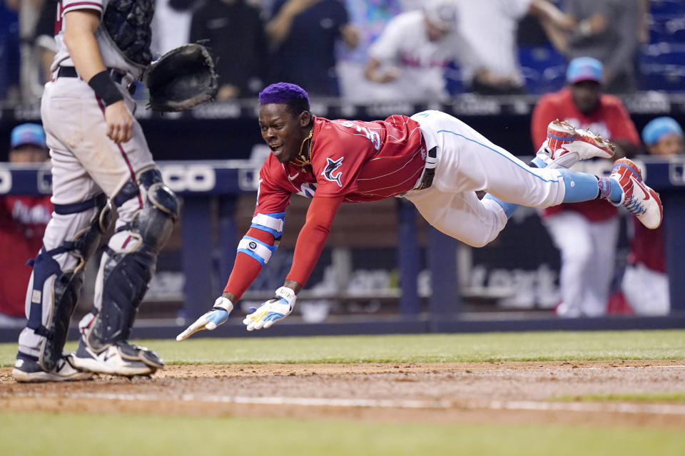 Miami Marlins' Jazz Chisholm Jr. scores on an inside-the-park home run during the fifth inning of the team's baseball game against the Atlanta Braves, Saturday, July 10, 2021, in Miami. (AP Photo/Lynne Sladky)