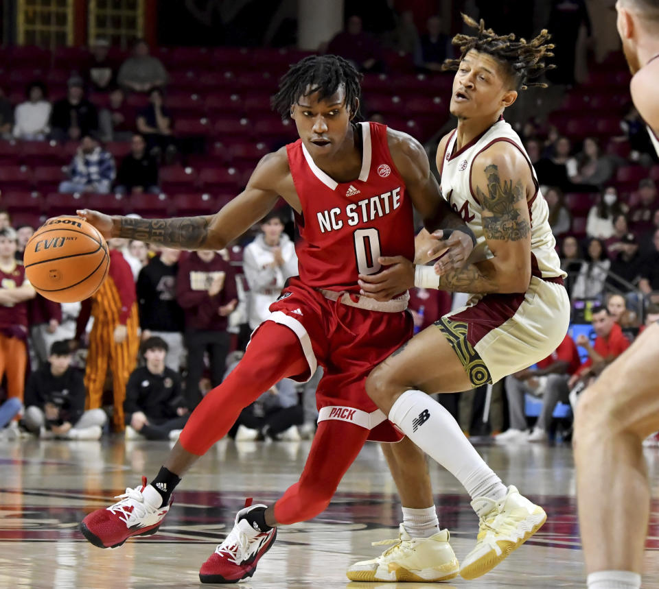 North Carolina State's Terquavion Smith (0) bumps into Boston College's Makai Ashton-Langford (11) during the first half of an NCAA college basketball game, Saturday, Feb. 11, 2023, in Boston. (AP Photo/Mark Stockwell)