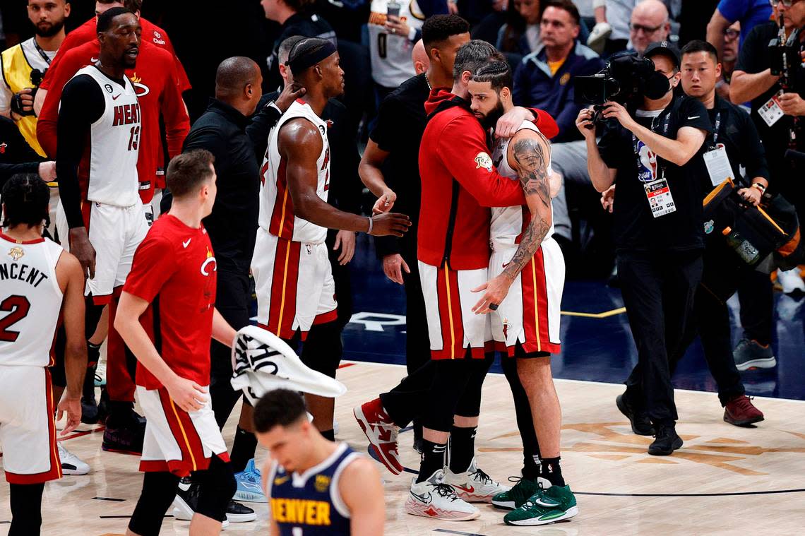 Miami Heat forward Kevin Love (42) and forward Caleb Martin (16) embrace after defeating the Denver Nuggets in game two of the 2023 NBA Finals at Ball Arena.