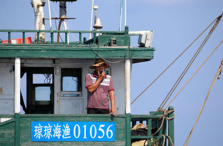 A Chinese fisherman talks on a two way radio while aboard a Chinese fishing vessel at the disputed Scarborough Shoal April 6, 2017. Picture taken April 6, 2017 REUTERS/Erik De Castro