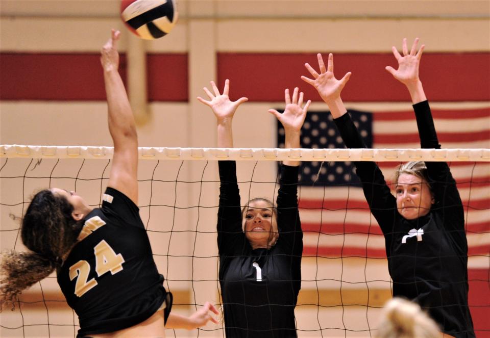 Clyde's Payton Phillips, center, and Liz Underwood defend as Abilene High's Mia Cairo hits the ball. Clyde won the Bev Ball Classic consolation semifinal match 20-25, 27-25, 25-19 last season at Cooper's auxiliary gym. Both teams return this year.