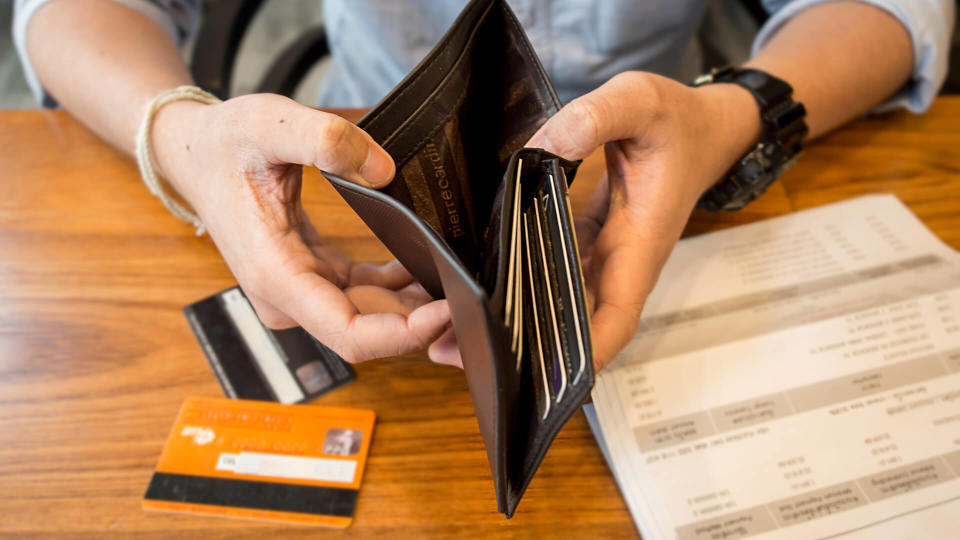 credit card debt - holding an empty wallet.