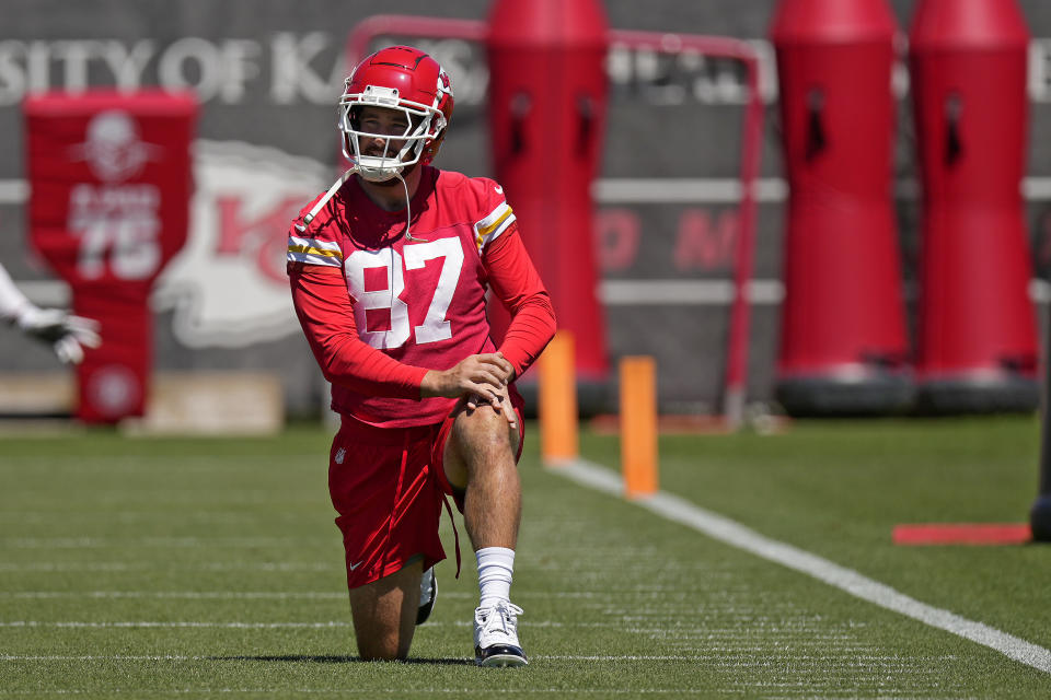 Kansas City Chiefs tight end Travis Kelce stretches during the NFL football team's organized team activities Friday, June 7, 2024, in Kansas City, Mo. (AP Photo/Charlie Riedel)