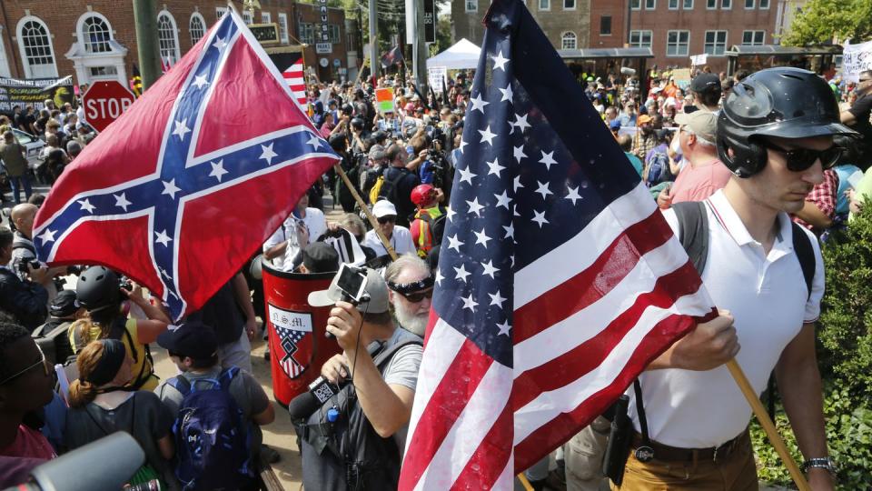 White nationalist demonstrators walk into Lee park surrounded by counter demonstrators in Charlottesville, Va., on Aug. 12, 2017. (Steve Helber/AP)