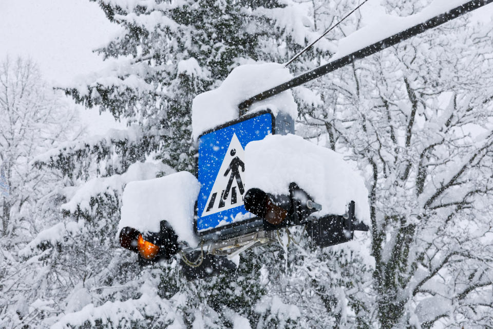 A road sign is covered by snow in Kocevje, near Ljubljana Slovenia, Monday, Jan. 23, 2023. A snow storm with gust winds has hampered traffic on a key highway in Slovenia on Monday and left parts of the country temporarily without electricity. (AP Photo)