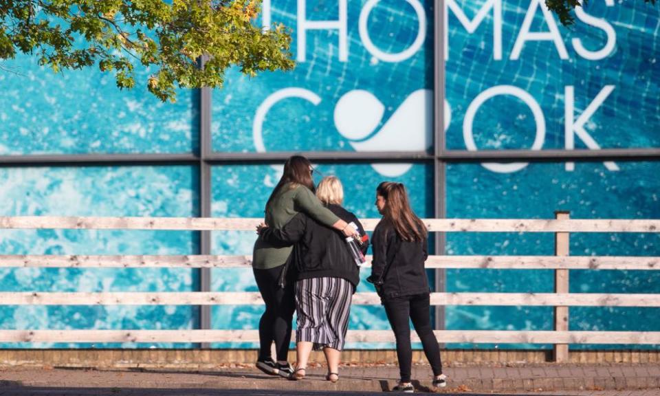 People comfort each other outside the Peterborough headquarters of Thomas Cook.