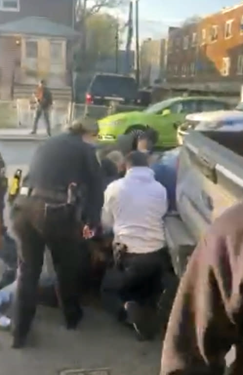 In this April 29, 2020 image made from video provided by Adegoke Atunbi, New York City police officers wrestle a man to the ground while making an arrest in the Brooklyn borough of New York. The video is among those posted on social media recently that show the NYPD using physical force while out enforcing the city's 6-foot-of-distance social distance rule. Despite mounting pressure from watchdogs to stop using police to enforce social distancing, Mayor Bill de Blasio stood by the practice on Thursday, May 7, saying: “We’re not going to sideline the NYPD." (Adegoke Atunbi via AP)