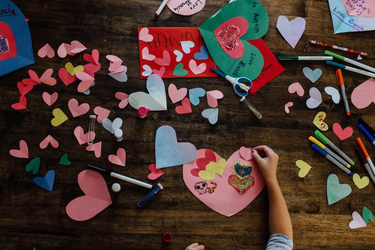 overhead view of girl creating valentines crafts and cards