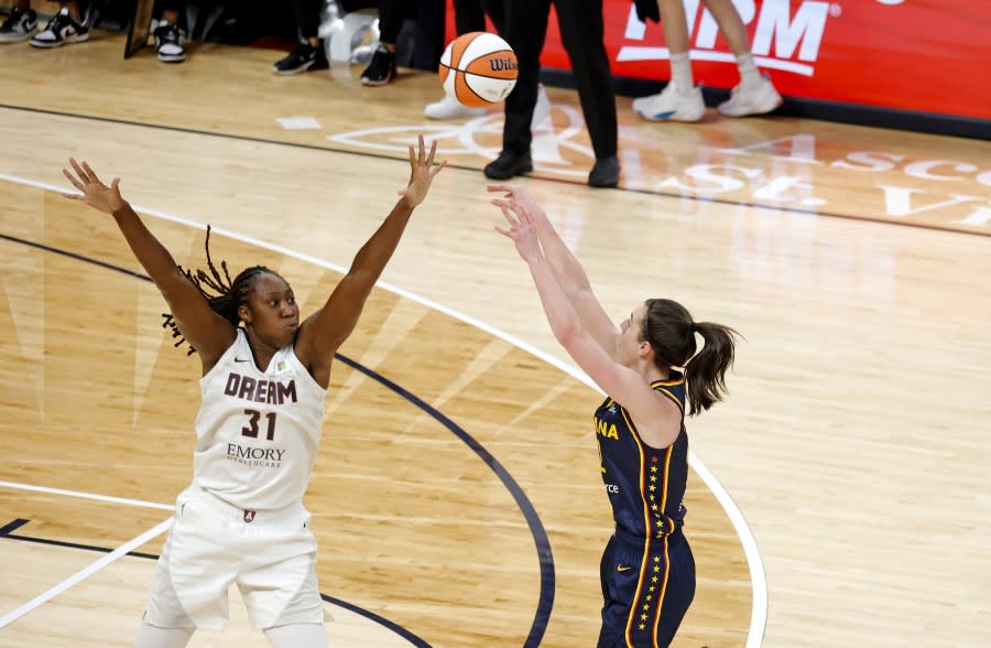INDIANAPOLIS, IN – MAY 09: Indiana Fever guard Caitlin Clark (22) takes a shot against Atlanta Dream forward Tina Charles (31) during a WNBA preseason game on May 9, 2024, at Gainbridge Fieldhouse in Indianapolis, Indiana. (Photo by Brian Spurlock/Icon Sportswire via Getty Images)