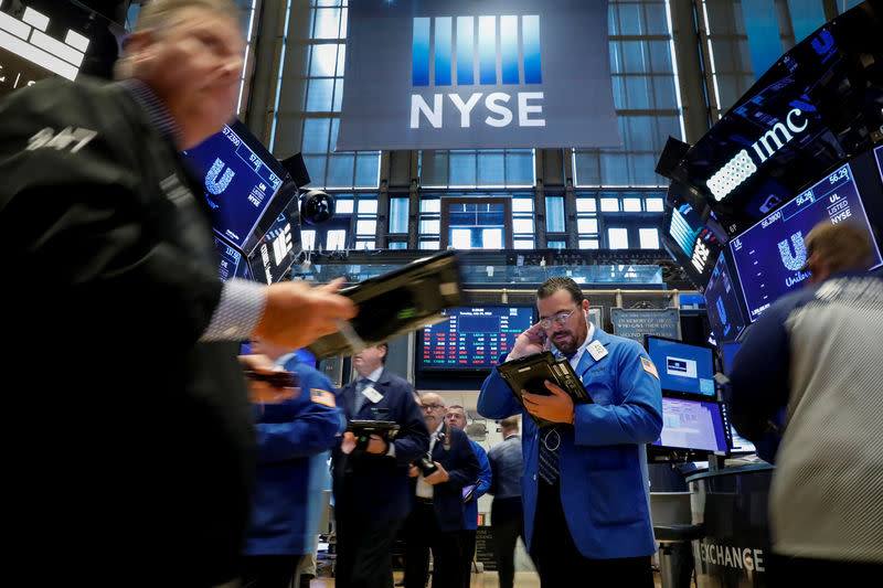 FILE PHOTO: Traders work on the floor of the New York Stock Exchange (NYSE) in New York, U.S., July 24, 2018. REUTERS/Brendan McDermid