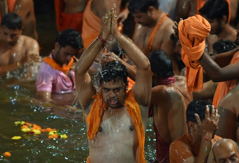 An Indian Hindu pilgrim takes the first holy dip at the Kumbh Mela in Trimbakeshwar near Nashik on August 29, 2015