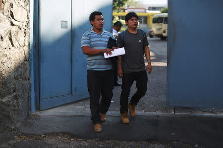 Deportees walk out at an immigration facility after a flight carrying illegal immigrants from the U.S. arrived in San Salvador, El Salvador, January 11, 2018. Picture taken January 11, 2018. REUTERS/Jose Cabezas