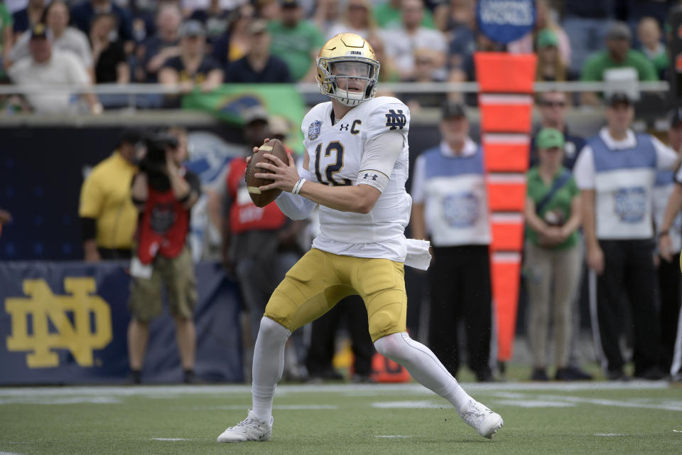 Notre Dame quarterback Ian Book (12) sets up to throw a pass during the first half of the Camping World Bowl NCAA college football game against Iowa State Saturday, Dec. 28, 2019, in Orlando, Fla. (AP Photo/Phelan M. Ebenhack)