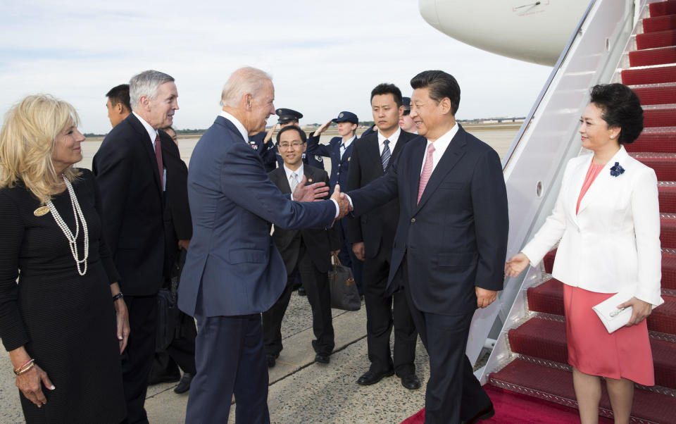 Chinese President Xi Jinping, second right, and his wife Peng Liyuan, first right, are welcomed by then-Vice President Joe Biden and his wife to Andrews Air Force Base in Washington D.C., September 24, 2015.  / Credit: Xinhua/Huang Jingwen/Getty