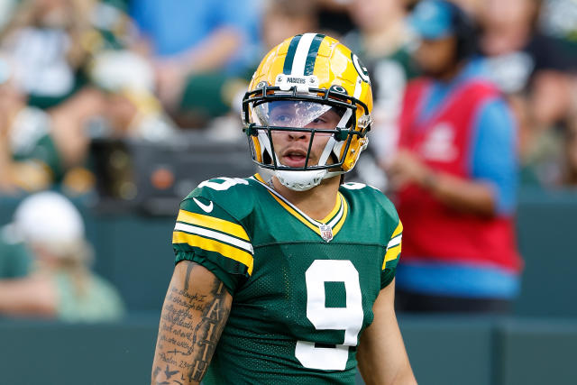 Christian Watson of the Green Bay Packers warms up before the