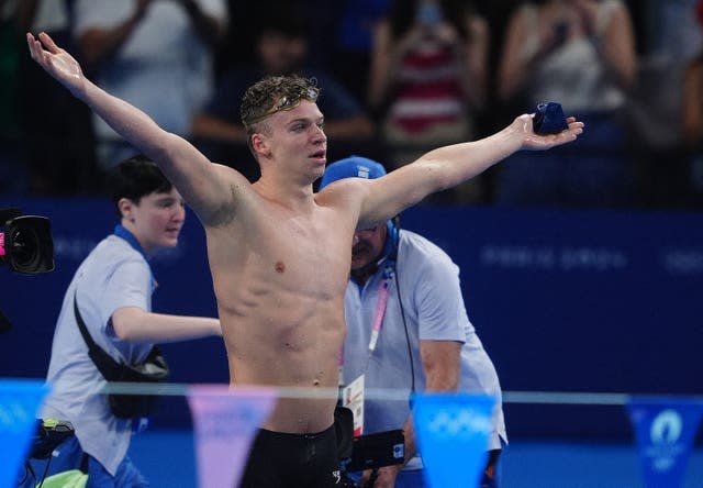 Leon Marchand celebrates winning the gold medal in the men's 200-meter individual medley